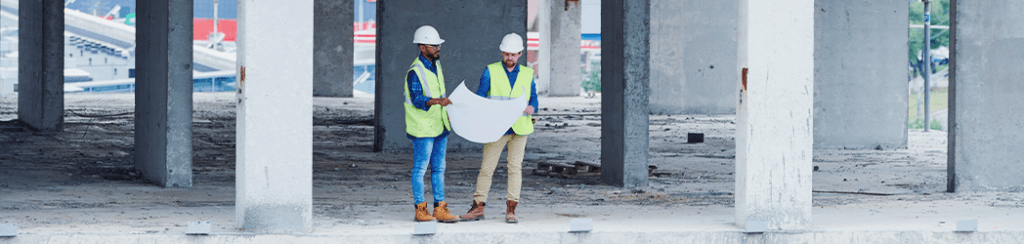 They discuss construction industry standards while going over building blueprints
