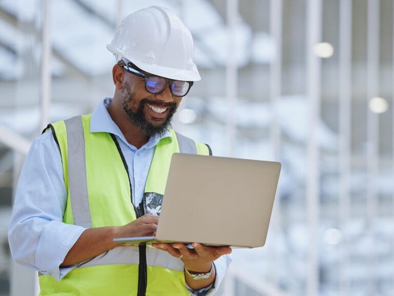 Construction employee aligning construction documentation for streamlined project processes